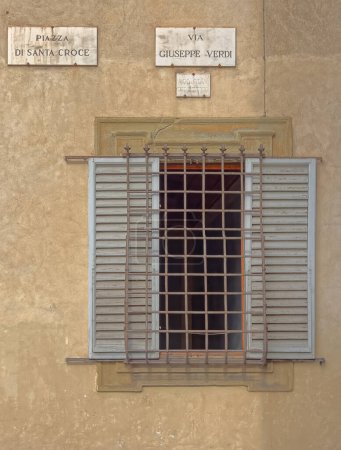 Photo for FLORENCE, ITALY - September 25, 2019 Narrow street window with protective grill and shutters in old city center. - Royalty Free Image