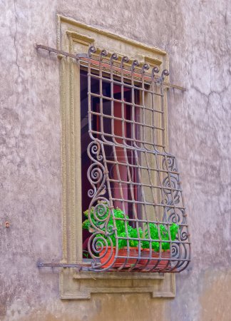 Photo for Narrow street window with protective grill and shutters in old city center of Florence Italy. - Royalty Free Image