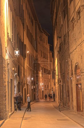 Photo for FLORENCE, ITALY - September 25, 2019 Narrow street in old city center by night. - Royalty Free Image