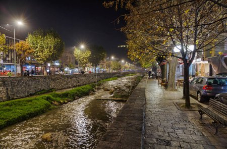 Photo for PRIZREN, KOSOVO - NOVEMBER 12, 2022: People walking by river Bistrica at cold november night. - Royalty Free Image