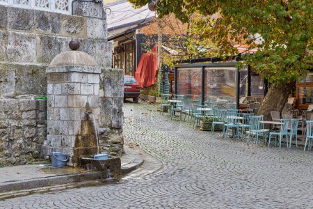 Photo for PRIZREN, KOSOVO - NOVEMBER 13, 2022: Old stone fountain by Ottoman Sinan Pasha mosque in historical city center. - Royalty Free Image