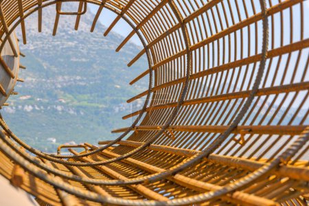 Photo for View through a wire mesh cylinder at a construction site in Korcula. - Royalty Free Image