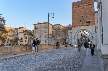 Photo for PADUA, ITALY - APRIL 01 2023: People walk Ponte Molino, Roman bridge across the Bacchiglione river at this place begins the old town which is entered by the Porta e Ponte Molino. - Royalty Free Image
