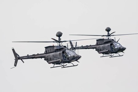 Photo for VARAZDIN, CROATIA - July 21, 2018: Two OH-58D Kiowa Warrior helicopters of the Croatian military flyby during an airshow. - Royalty Free Image