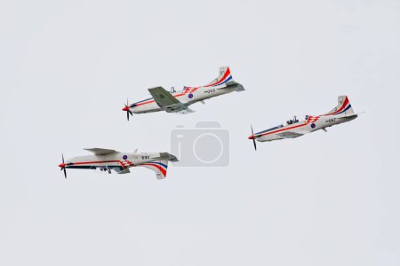 Photo for VARAZDIN, CROATIA - July 21, 2018: The Wings of Storm aerobatic team soars above, skillfully maneuvering three aircraft in formation during an airshow. - Royalty Free Image