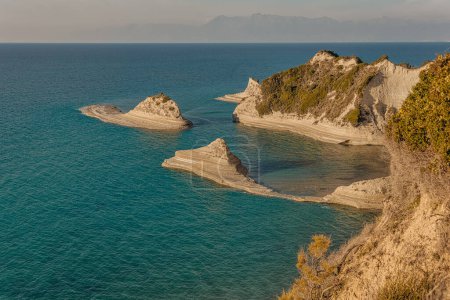 Photo for Panoramic view of Cape Drastis coast rocks in Corfu, bathed in the soft light moments before sunset. - Royalty Free Image