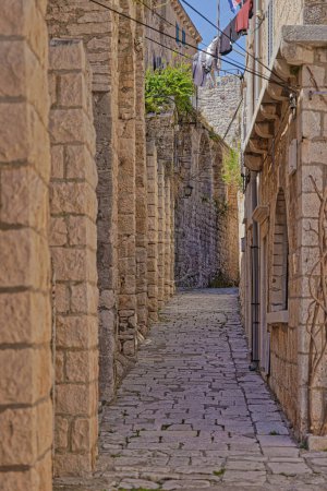 Téléchargez les photos : Une ruelle pittoresque en pierre étroite nichée dans le cœur historique de Korcula. - en image libre de droit
