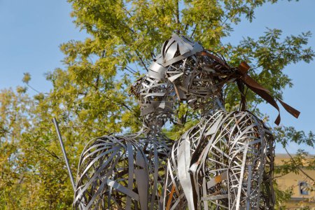 Photo for TIRANA, ALBANIA - September 30, 2019: Metal sculpture depicting two figures in a park along a promenade near Skenderbeg Square. - Royalty Free Image