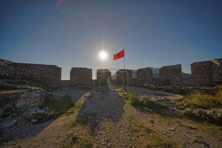 Photo for A vibrant sunset at Rozafa fortress, Shkoder with the Albanian flag waving gracefully. - Royalty Free Image