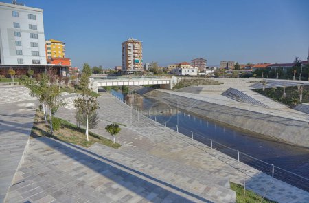 Foto de FIER, ALBANIA - 20 de octubre de 2022: El vibrante centro de la ciudad de Fier, con la plaza principal y el pintoresco río Gjanica que fluye a través de un canal bien mantenido en la ciudad. - Imagen libre de derechos