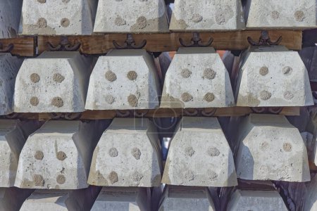 Photo for Rows of neatly stacked concrete railway sleepers present an orderly pattern against the backdrop of Krizevcis clear skies. - Royalty Free Image