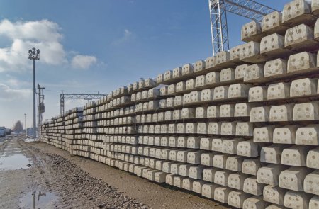 Rows of neatly stacked concrete railway sleepers present an orderly pattern against the backdrop of Krizevcis clear skies.