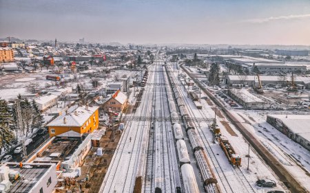 Téléchargez les photos : Vue surélevée de la gare enneigée de Krizevci, capturant l'essence du transport hivernal et de la vie urbaine. - en image libre de droit
