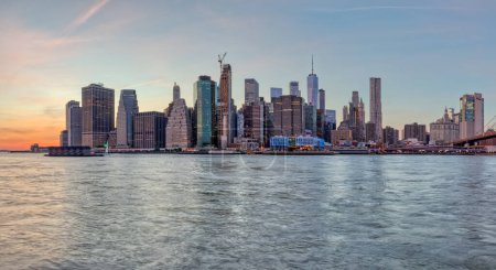 Photo for NEW YORK, USA - OCTOBER 01, 2018: Large stiched panorama of the Manhattan downtown at sunset from the Brooklyn Bridge Park. - Royalty Free Image