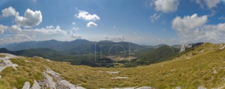 Photo for Sweeping views of the lush, rolling hills and valleys of Baske Ostarije as seen from the peak of Ljubicko Brdo under a cloud-dappled sky. - Royalty Free Image
