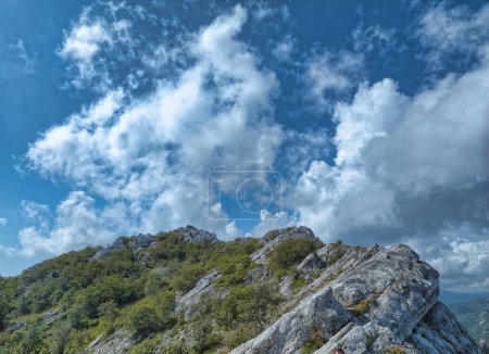 Foto de El escarpado terreno de Ljubicko Brdo contrasta con la suavidad de las nubes, ofreciendo una pintoresca escena sobre la montaña Velebit. - Imagen libre de derechos
