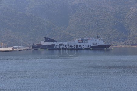 Photo for IGOUMENITSA, GREECE - October 23, 2023: Grimaldi Lines ferries are moored at the bustling port of Igoumenitsa, with the scenic backdrop of the Greek mountains. - Royalty Free Image