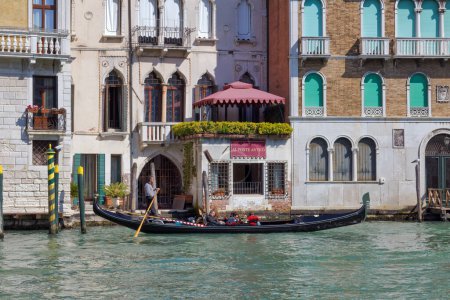 Photo for VENICE, ITALY - APRIL 10 2023: Gondola passing the Grand Canal. - Royalty Free Image