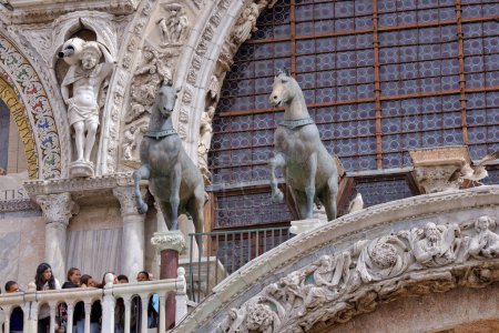Foto de VENECIA, ITALIA - 11 ABRIL 2023: Caballos de Bronce elementos decorativos en la fachada de la Basílica de San Marcos, que ofrece una visión de rico patrimonio arquitectónico. - Imagen libre de derechos