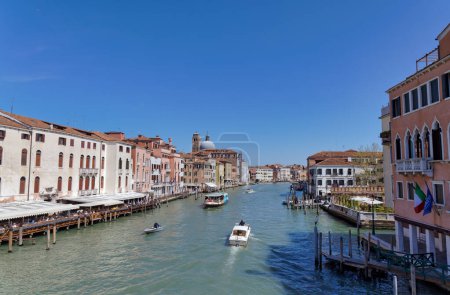 Photo for VENICE, ITALY - APRIL 11 2023: Boats passing the Grand Canal view from Stone Arch bridge Ponte degli Scalzi. - Royalty Free Image