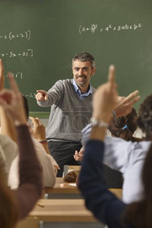 Photo for Math teacher giving lessons. Classroom with students. School education - Royalty Free Image