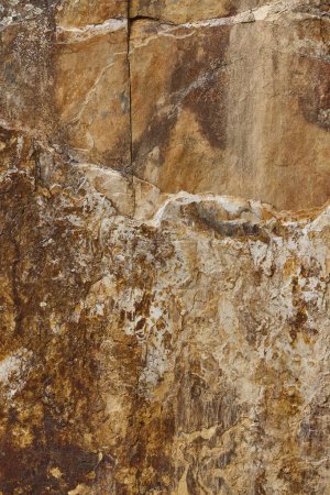 Textured stone wall in brown black color. Natural rough background