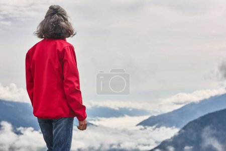 Photo for Woman looking a overcast valley in Salzburg state. Austria - Royalty Free Image