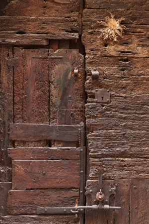 Photo for Antique wooden rustic door. Gate grunge textured exterior. Spain - Royalty Free Image