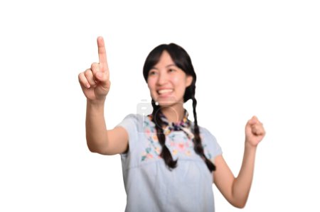 Photo for Portrait beautiful happy young asian woman in denim dress touching invisible screen on white background. - Royalty Free Image