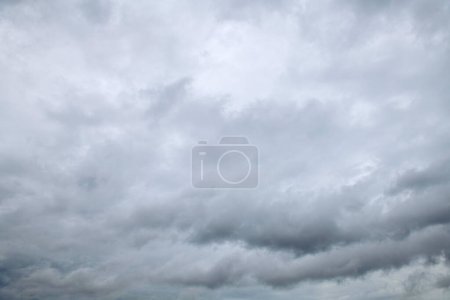 Téléchargez les photos : Storm clouds floating in a rainy day with natural light. Cloudscape scenery, overcast weather above blue sky. White and grey clouds scenic nature environment background. - en image libre de droit