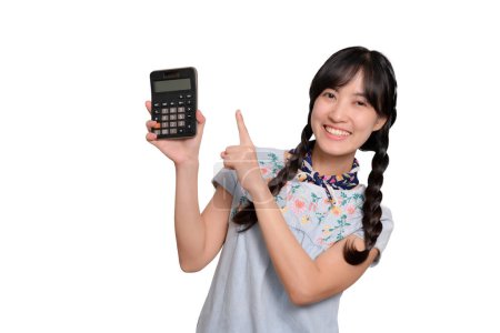 Téléchargez les photos : Portrait of beautiful happy young asian woman in denim dress holding calculator on white background. business shopping online concept. - en image libre de droit