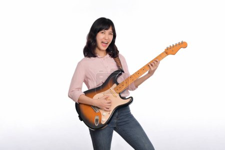 Photo for Asian woman playing a vintage sunburst electric guitar isolated on white background. - Royalty Free Image
