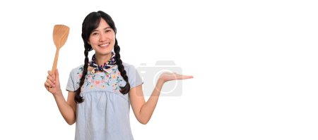 Photo for Portrait beautiful young asian woman smile in denim dress with spatula on white background - Royalty Free Image