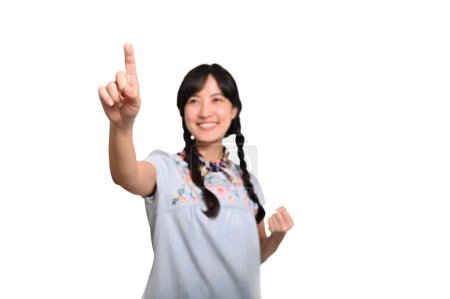 Téléchargez les photos : Portrait beautiful happy young asian woman in denim dress touching invisible screen on white background. - en image libre de droit
