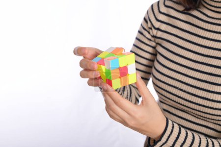 female hands holding a puzzle cube.
