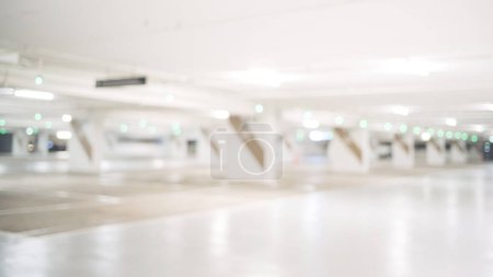 Photo for Blurred image of empty car park in basement of shopping mall. Defocused background concept - Royalty Free Image