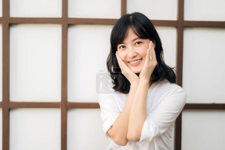 Photo for Portrait beautiful young asian woman happiness sitting on wooden grid wall, Happy female is smiling on wooden grid wall - Royalty Free Image