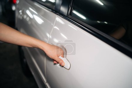 Photo for Business woman hand open person white car. Driver, service, lock, automotive insurance concept. Automobile vehicle female owner catching a door handle. - Royalty Free Image
