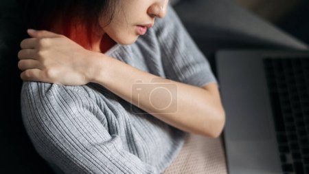 Photo for Asian woman has shoulder pain. Female holding painful shoulder with another hand. People with body-muscles problem - Royalty Free Image
