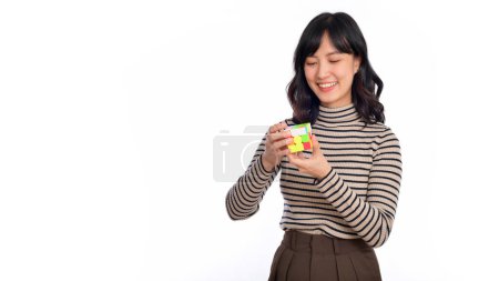 Photo for Solving cubic problems, problem solution and making strategic moves concept. Asian woman holding a puzzle cube standing on white background. - Royalty Free Image