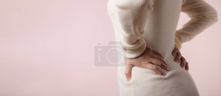 Photo for Young woman have back ache, waist pain, lumbar muscle injury problem. Office syndrome disease sick. Healthcare concept. - Royalty Free Image