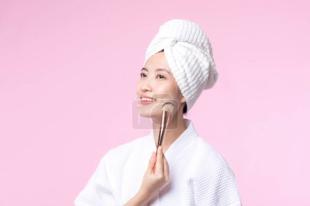 Photo for Portrait young happy asian woman with natural make up face holding cosmetic skin powder blusher isolated on pink background. Female apply skincare brush treatment. beauty product, cosmetology concept. - Royalty Free Image