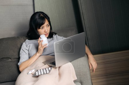 Photo for Sick asian woman with medicine having video call conference medical app in telehealth on laptop. - Royalty Free Image