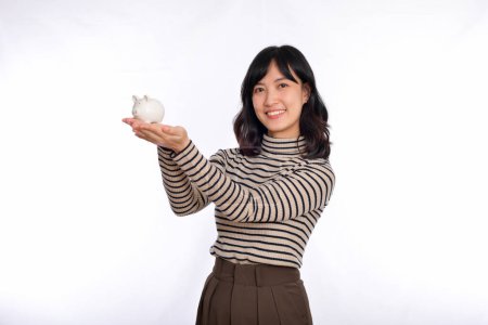 Photo for Portrait of young Asian woman holding white piggy bank isolated on white background, Financial and bank saving money concept - Royalty Free Image