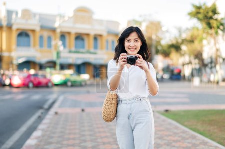 Photo for Portrait of young beautiful woman with camera explore street in Bangkok, Thailand - Royalty Free Image