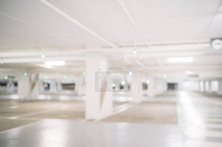 Photo for Blurred image of empty car park in basement of shopping mall. Defocused background concept - Royalty Free Image