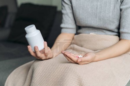 Photo for Closeup illness young female hand hold vitamin, medical pill capsule, antibiotic bottle. sick woman person with pain disease self health care medicine therapy with pharmacy tablet. - Royalty Free Image