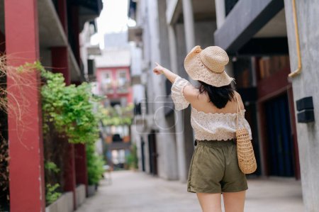Photo for Happy asian youth woman with camera travels street city trip on leisure weekend. Young hipster female tourist sightseeing summer urban Bangkok destination. Asia summer tourism concept. - Royalty Free Image
