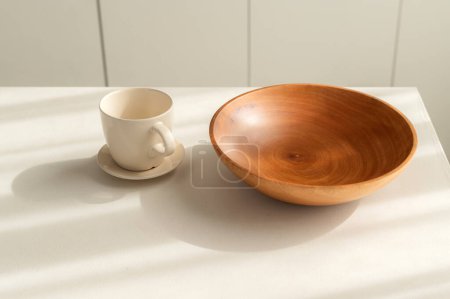 Photo for Step into clean and elegant kitchen with vintage charm. Simple and bright, round wooden tableware and utensils create still life of simplicity. hand made coffee cup and bowl. - Royalty Free Image