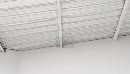 Photo for Industrial grade metal roof insulation. heat resistant sheet foil provides thermal protection and energy efficiency. corrugated design and silver texture add modern, abstract touch to construction. - Royalty Free Image